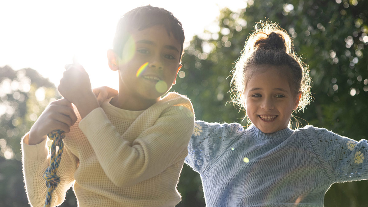 Children playing outside in the sunshine